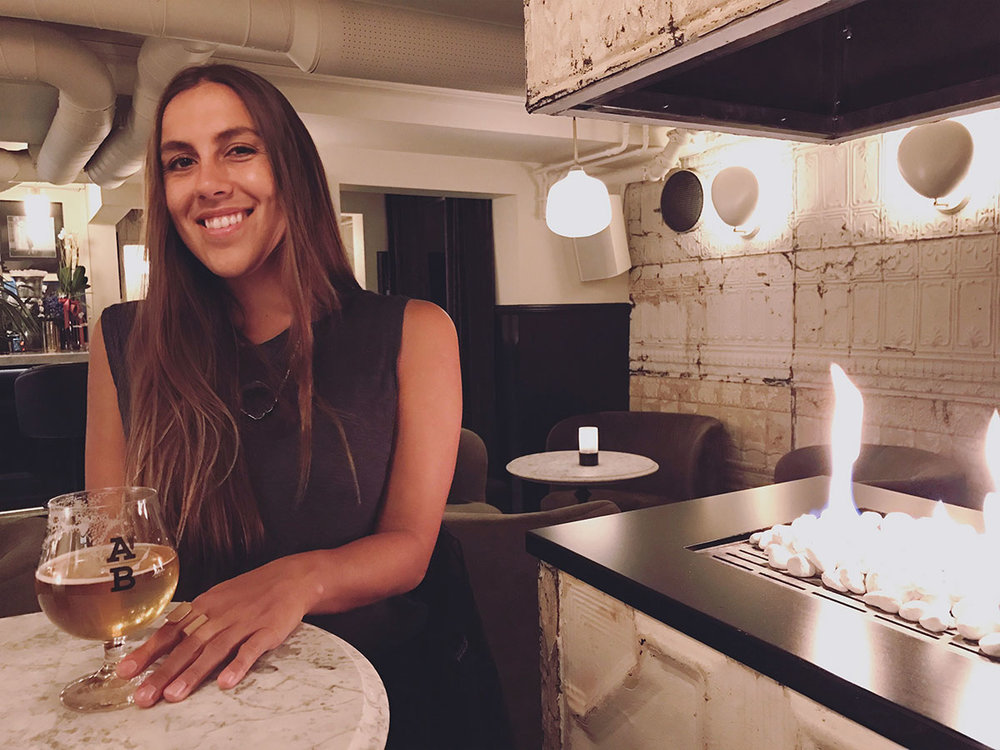 Sapphire &amp; Elm Travel co-founder,  Stephanie , enjoying a beer at underbar in oslo