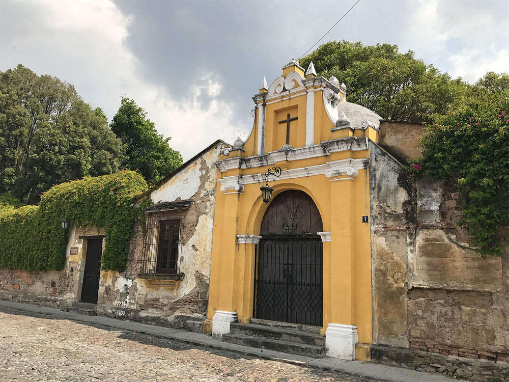 yellow church and cobbled streets in Antigua Guatemala