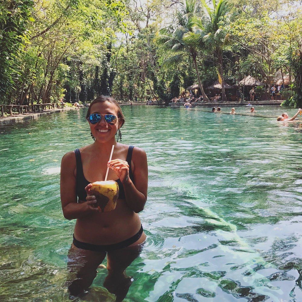sapphire &amp; elm travel co-founder, stephanie sipping on a coco loco at ojo de agua