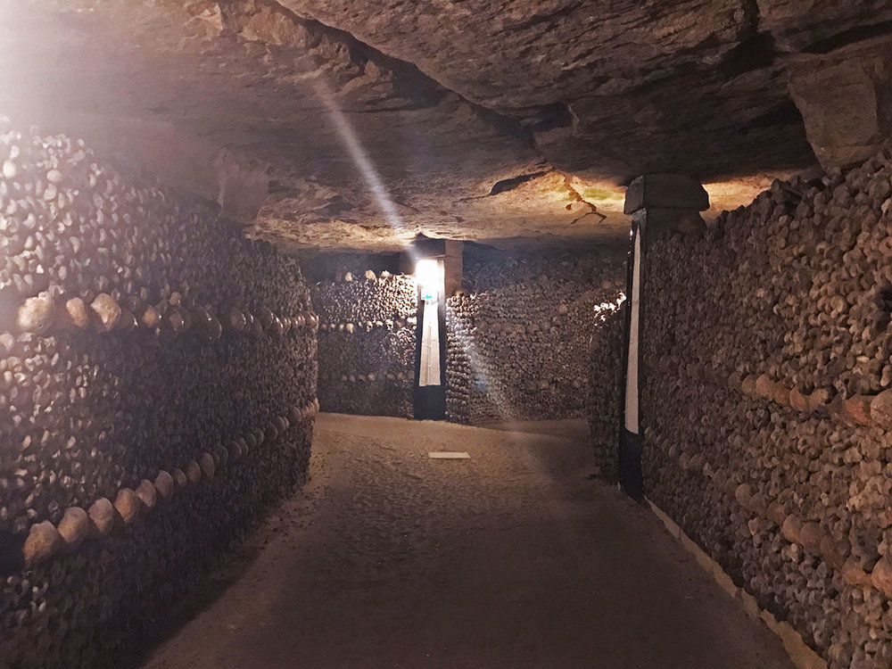 hallway of skeletons in Paris catacombs