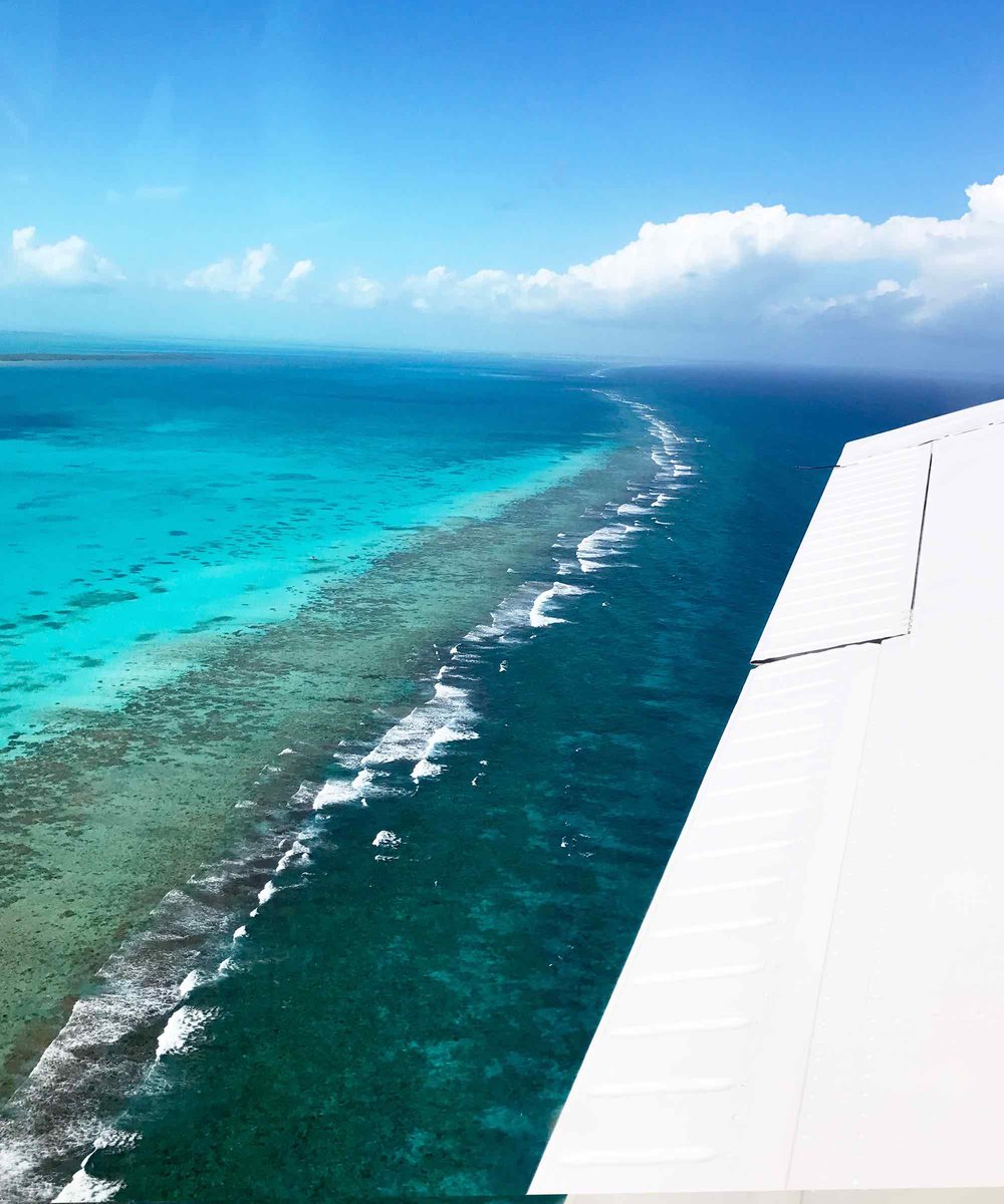 Flying over the Belize Barrier Reef to the Blue Hole