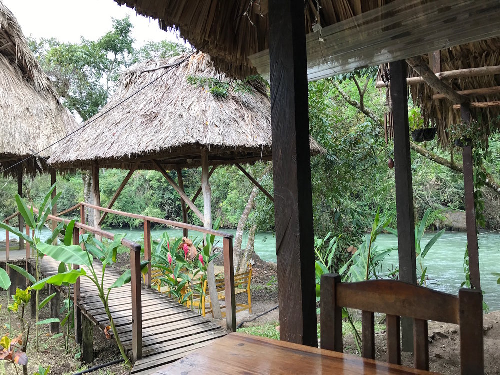 View of the river from the long communal dining tables in lanquin guatemala near semuc champey