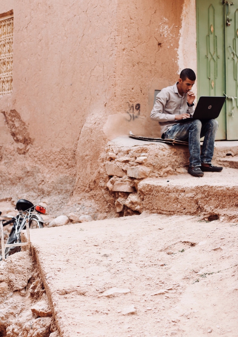 Marrakech man on laptop | The City that Inspired Fashion Icon, Yves Saint-Laurent Most